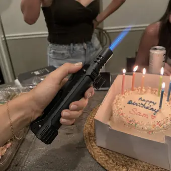 TacFlame jet flame lighting candles on a birthday cake